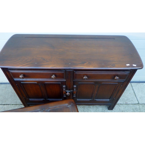 836 - A dark Ercol dresser base, 124cm wide together with a four panel blanket box (2)