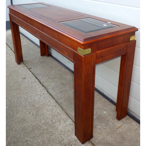 848 - A side table with glass inset top, 133cm long