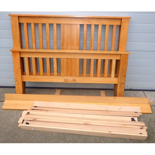 851 - A modern light oak double bed frame, 141cm wide