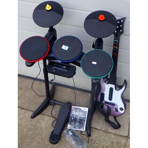868 - A set of Wii drums, microphone and a guitar, a/f sold as seen, missing sticks, with two games