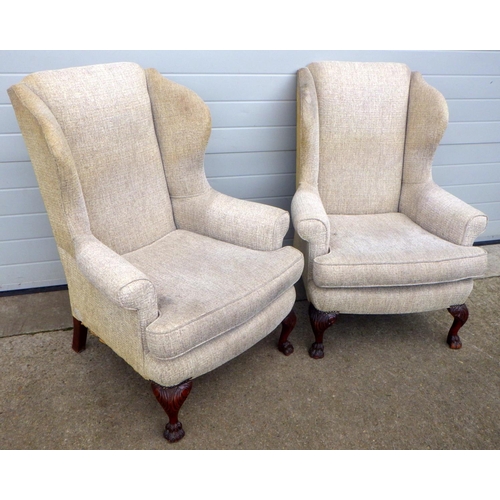 872 - A pair of wingback armchairs, on carved paw feet, upholstery a/f