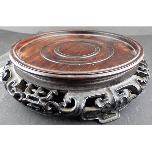 221 - An Oriental hardwood carved stand (14.5cm inner diameter)