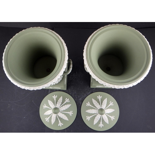 225 - A pair of Wedgwood Sage Green Jasperware twin-handled lidded urns 29cm tall