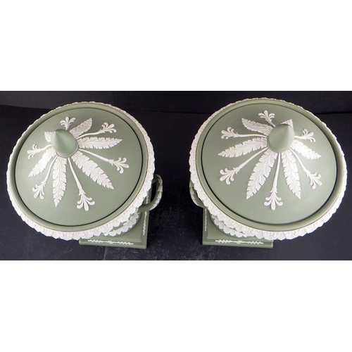 225 - A pair of Wedgwood Sage Green Jasperware twin-handled lidded urns 29cm tall