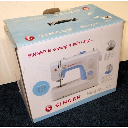 283 - A boxed Singer Simple 3221 electric sewing machine, ALL ELECTRICALS SOLD AS SEEN