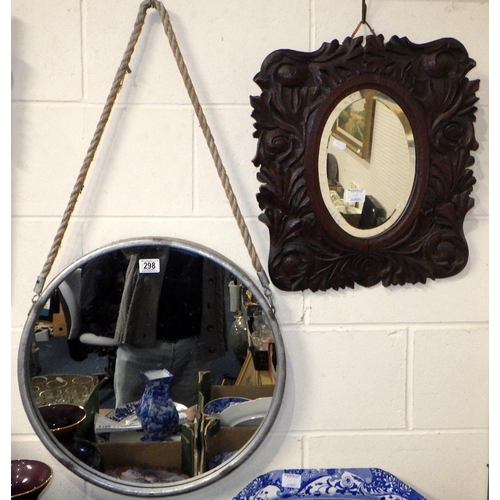 298 - A circular aluminium framed mirror 52cm diameter together with a carved oak mirror (2)