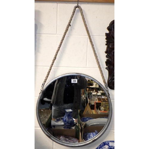 298 - A circular aluminium framed mirror 52cm diameter together with a carved oak mirror (2)