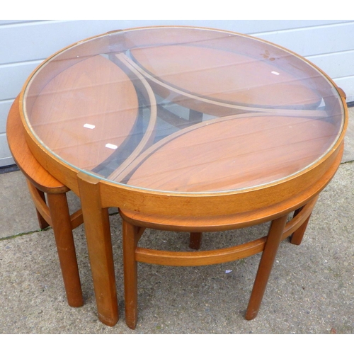 635 - A circular glass topped coffee table with 3 under tables, 82cm across, (Trinity Nest of Tables by Na... 