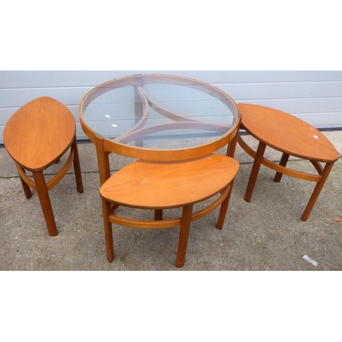 635 - A circular glass topped coffee table with 3 under tables, 82cm across, (Trinity Nest of Tables by Na... 