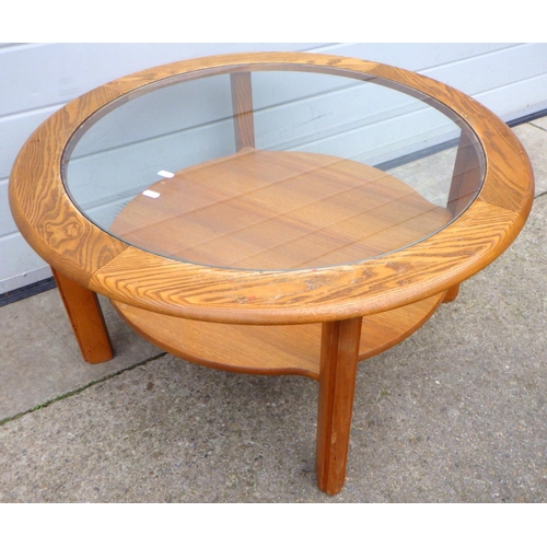 663 - A circular glass topped coffee table, 84cm across