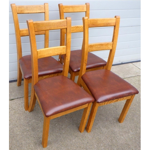 664 - A set of four modern oak dining chairs, seats worn