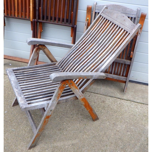 676 - A set of four folding teak garden chairs together with two similar garden armchairs