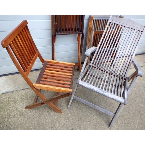 676 - A set of four folding teak garden chairs together with two similar garden armchairs