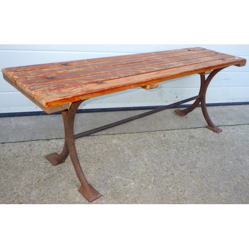 696 - A bench with cast iron base, later top, 122cm long