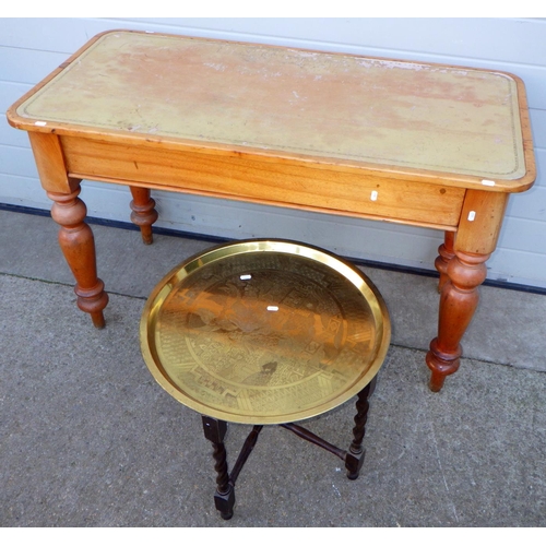 698 - A leather topped table, 122cm wide together with a brass topped folding occasional table (2)