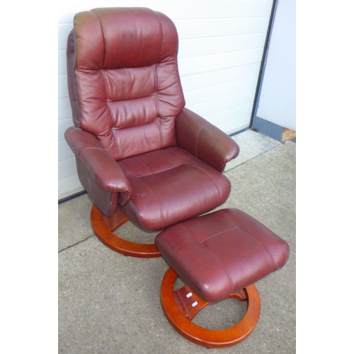 705 - A brown leather swivel easy chair with footstool (2)