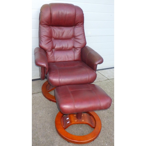 705 - A brown leather swivel easy chair with footstool (2)