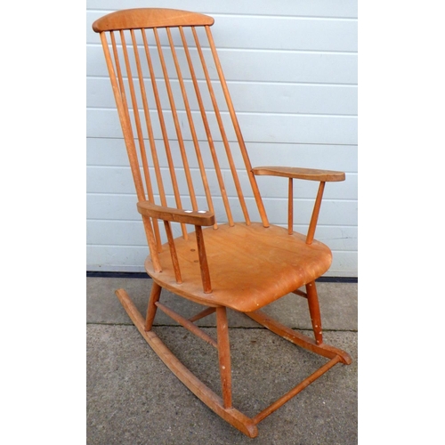 711 - A blonde stick back rocking chair