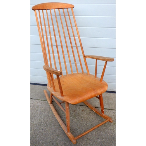 711 - A blonde stick back rocking chair