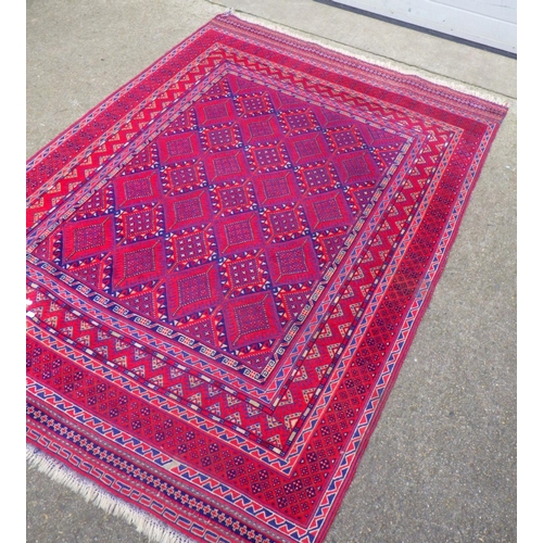 715 - A red ground rug, 202cm x 141cm