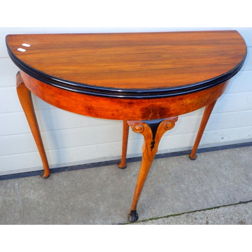 721 - A walnut demi-lune tea table on cabriole legs, 84cm wide