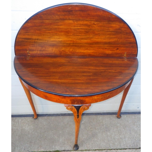 721 - A walnut demi-lune tea table on cabriole legs, 84cm wide