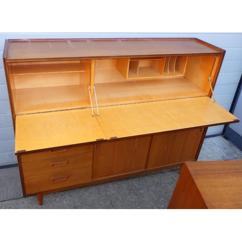 749 - A teak sideboard, 141cm wide together with a low bookcase, feet repaired and a corner cabinet (3)