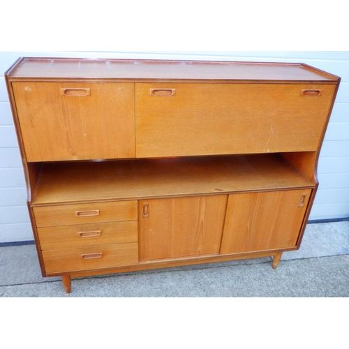 749 - A teak sideboard, 141cm wide together with a low bookcase, feet repaired and a corner cabinet (3)