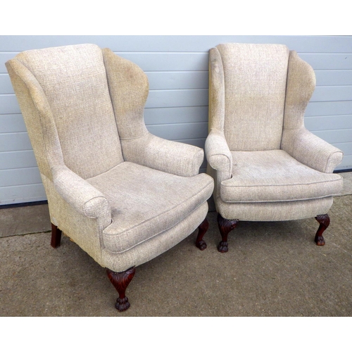 756 - A pair of wingback armchairs, on carved paw feet, upholstery a/f