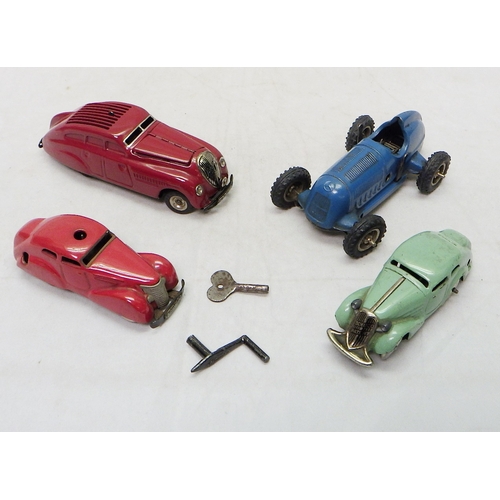 328 - A Gescha Patent Mercedes clockwork racing car toy; three Schuco clockwork toy cars.  A/F (4)