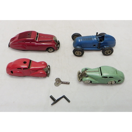 328 - A Gescha Patent Mercedes clockwork racing car toy; three Schuco clockwork toy cars.  A/F (4)