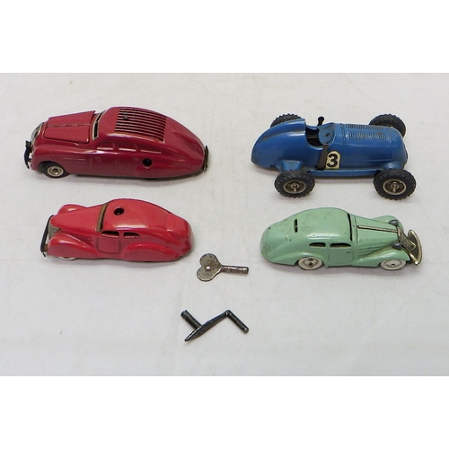 328 - A Gescha Patent Mercedes clockwork racing car toy; three Schuco clockwork toy cars.  A/F (4)