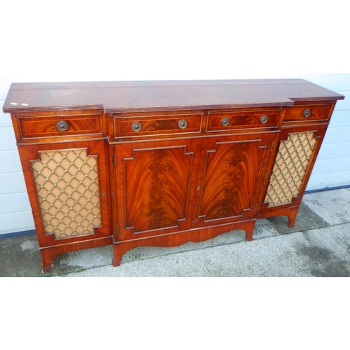 764 - A reproduction mahogany four door , breakfront sideboard with end grille doors, marks , 152cm long