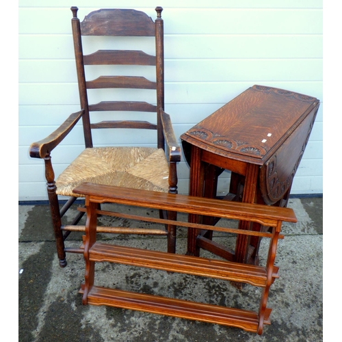 778 - A carved oak gateleg table, feet a/f together with a hanging shelf and a ladderback chair (3)
