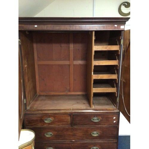 754 - A 19th cen mahogany linen press with oval panelled doors, 132cm wide, missing cornice side