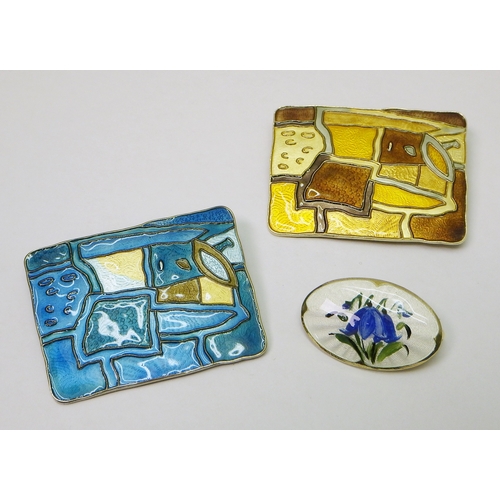 45 - Two David-Andersen panel brooches, white metal and enamel, each 44 x 34mm; another Norwegian white m...