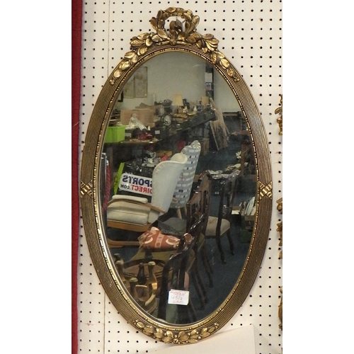 48 - Two gilt framed oval bevelled mirror 65 & 100cm high