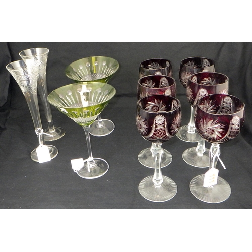 111 - A set of six Bohemian wine glasses together with two large green cocktail glasses and two Champagne ... 