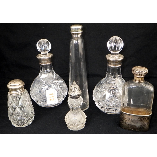 112 - A pair of silver collared decanters together with three silver topped bottles and a further long nar... 