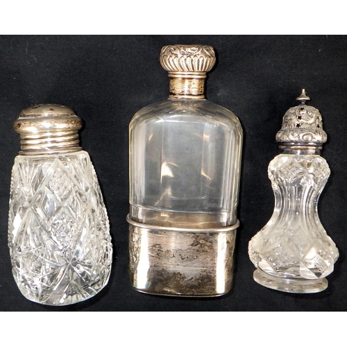 112 - A pair of silver collared decanters together with three silver topped bottles and a further long nar... 