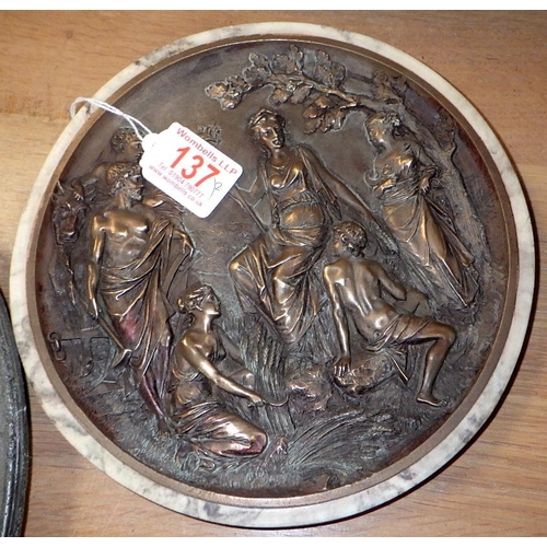 137 - An oval heavy cast metal relief plaque together with a circular wall plaques (2)