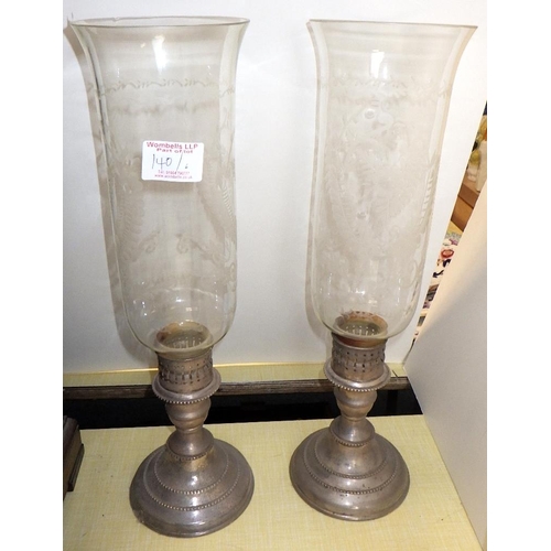 140 - A pair of etched glass hurricane lamps together with a pair of candlesticks and two pairs of spill v... 