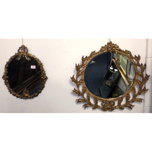 167 - A mid century overpainted circular bevelled mirror 70cm diameter, together with a cast metal oval mi... 