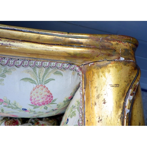 869 - A giltwood framed three seat settee on cabriole legs, frame loose, 215cm wide