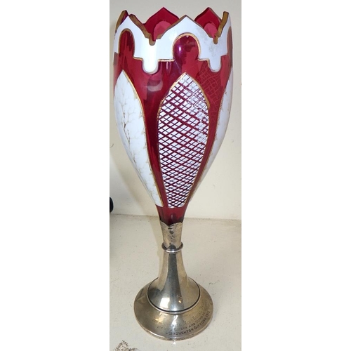 251 - A Bohemian overlay glass vase with a silver base 30cm tall