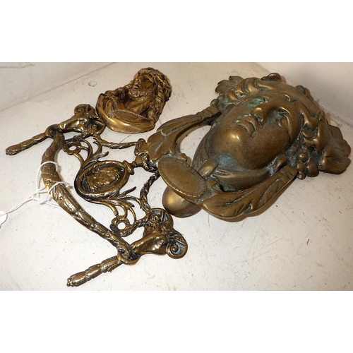 254 - A Brass door knocker together with a handle and a small Christ plaque (3)