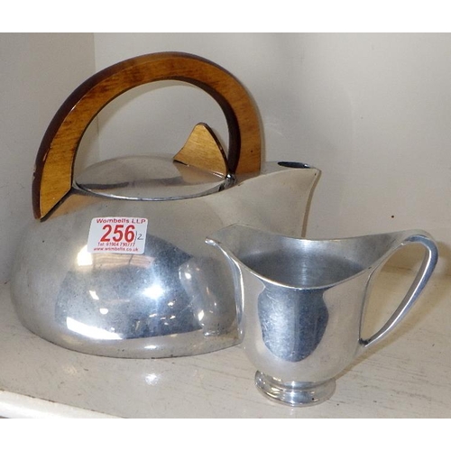 256 - A Piquot ware stove kettle together with a matching milk jug (2)