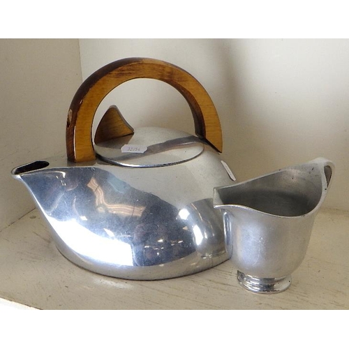 256 - A Piquot ware stove kettle together with a matching milk jug (2)