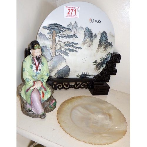 271 - A Chinese porcelain plate mounted on a hardwood stand together with a small seated figure of a man a... 