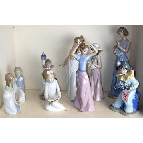 282 - Two small Lladro figures with blankets together with 7 Nao figures (9)